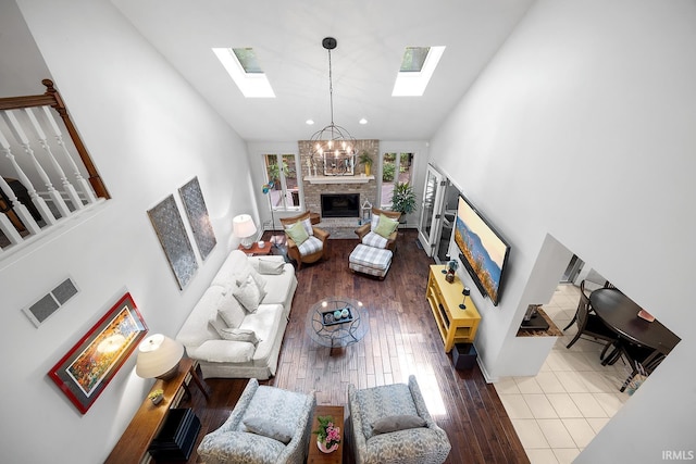 125 Durkees Run Dr, Lafayette, IN 47905 - living room featuring a skylight, a fireplace, high vaulted ceiling, and wood finished floors