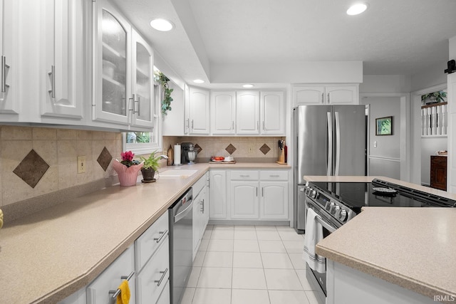 125 Durkees Run Dr, Lafayette, IN 47905 - kitchen with stainless steel appliances, a sink, white cabinetry, recessed lighting, and decorative backsplash