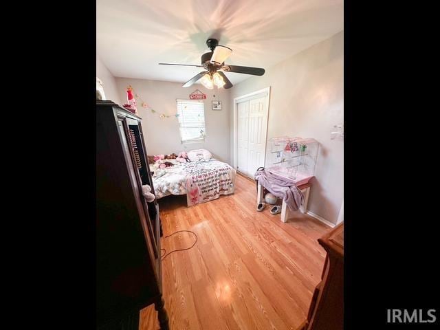 11239 Thomas Dr, Evansville, IN 47712 - bedroom with light wood-style flooring, a closet, and ceiling fan