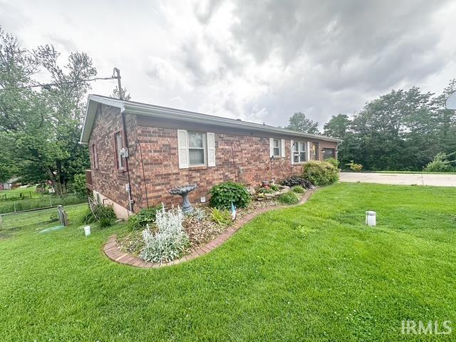 11239 Thomas Dr, Evansville, IN 47712 - view of property exterior with a yard and brick siding