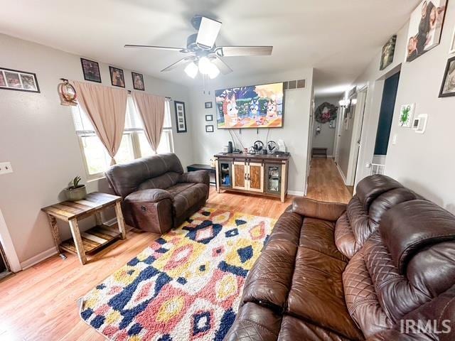 11239 Thomas Dr, Evansville, IN 47712 - living room with a ceiling fan, wood finished floors, and baseboards