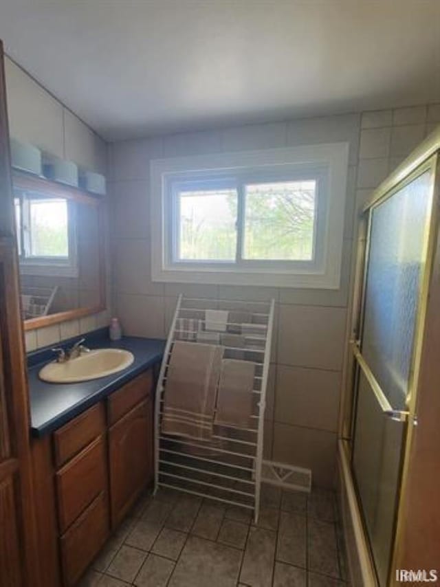 2347 E Navaho Dr, Vincennes, IN 47591 - full bath featuring vanity, tile patterned floors, and tile walls