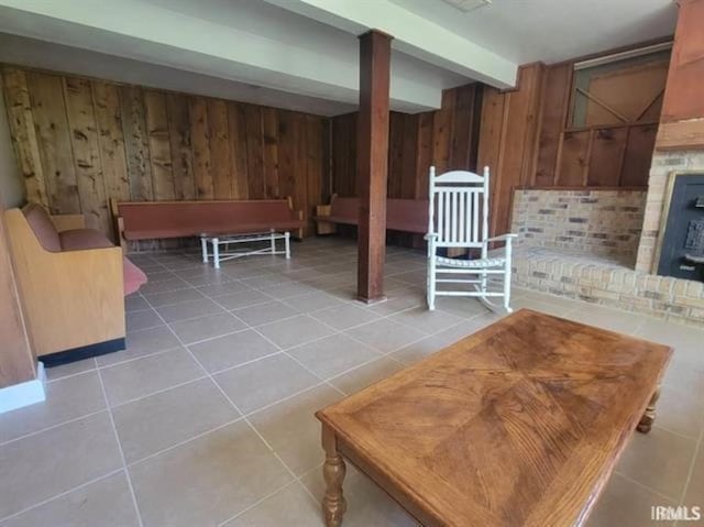 2347 E Navaho Dr, Vincennes, IN 47591 - living room featuring wood walls, tile patterned flooring, and beamed ceiling