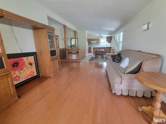 2347 E Navaho Dr, Vincennes, IN 47591 - living area with light wood-style flooring, lofted ceiling, and a chandelier