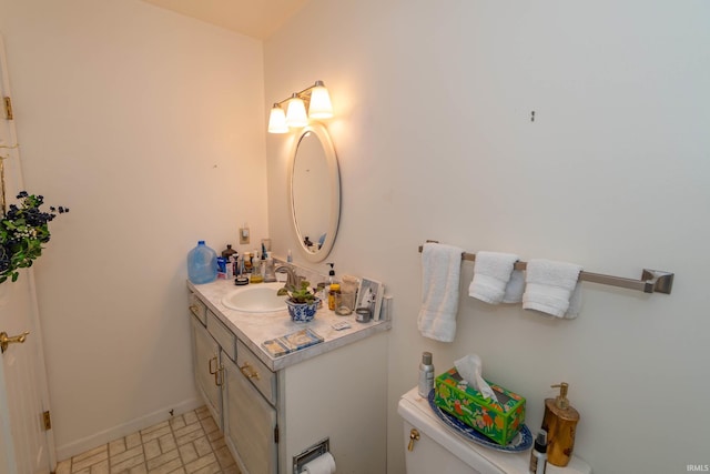 5717 Bayswater Pl, South Bend, IN 46614 - half bath with toilet, vanity, baseboards, and brick patterned floors