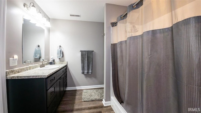 2014 Buell Dr, Angola, IN 46703 - bathroom with wood finished floors, vanity, baseboards, and curtained shower