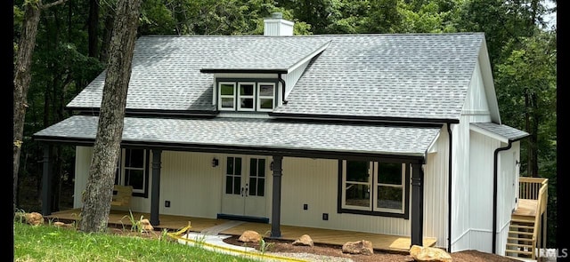 7017 S Harmony Rd, Bloomington, IN 47403 - view of front facade featuring roof with shingles, covered porch, a chimney, and french doors