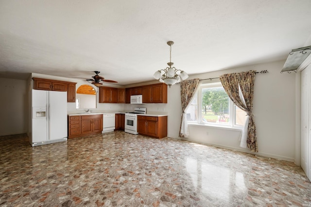 217 Vasbinder Dr, Anderson, IN 46017 - kitchen featuring white appliances, a sink, light countertops, ceiling fan, and a chandelier