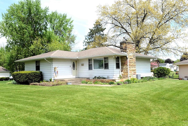 328 N Harding Ave, Mishawaka, IN 46544 - view of front facade with a front yard, a chimney, and a shingled roof