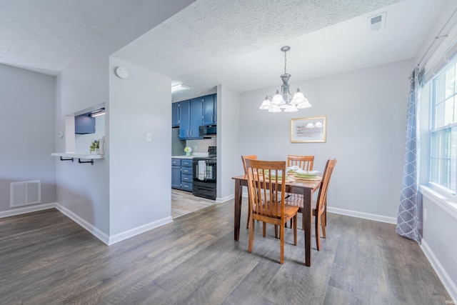 3417 S Westminster Way, Bloomington, IN 47401 - dining space with wood finished floors, a chandelier, baseboards, and a textured ceiling