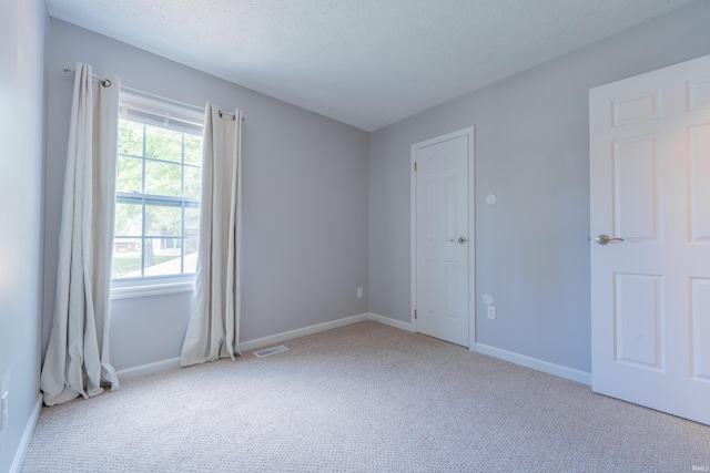3417 S Westminster Way, Bloomington, IN 47401 - empty room featuring carpet flooring, baseboards, and a textured ceiling