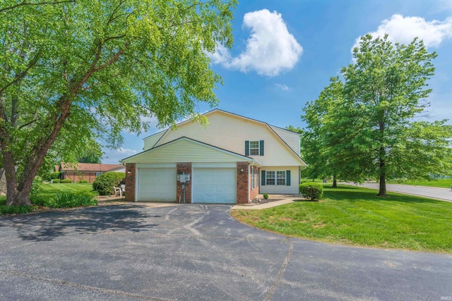 3417 S Westminster Way, Bloomington, IN 47401 - colonial inspired home with driveway, a front lawn, brick siding, a gambrel roof, and a garage