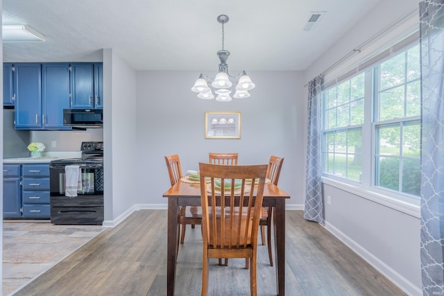 3417 S Westminster Way, Bloomington, IN 47401 - dining area with light wood-type flooring, a chandelier, and healthy amount of natural light
