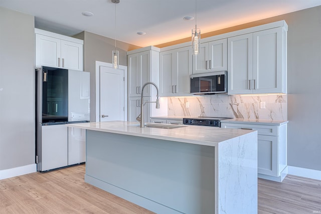 3605 Sand Dr, Newburgh, IN 47630 - kitchen featuring stainless steel microwave, freestanding refrigerator, a sink, range, and decorative backsplash