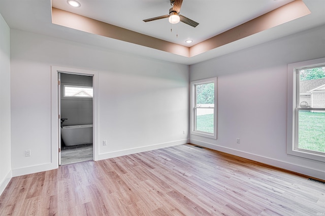 3605 Sand Dr, Newburgh, IN 47630 - empty room featuring a tray ceiling, light wood-style flooring, a ceiling fan, baseboards, and recessed lighting