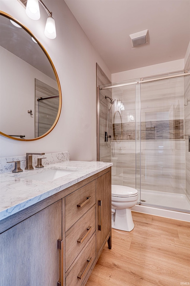 3605 Sand Dr, Newburgh, IN 47630 - full bath featuring toilet, a shower stall, wood finished floors, and vanity