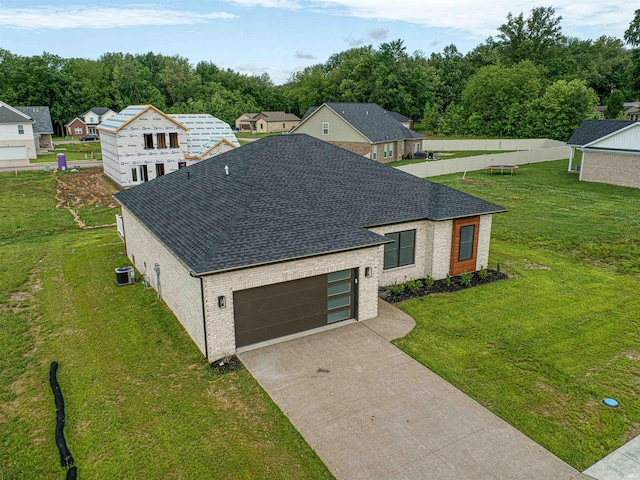 3605 Sand Dr, Newburgh, IN 47630 - view of front of house featuring a shingled roof, cooling unit, an attached garage, and brick siding