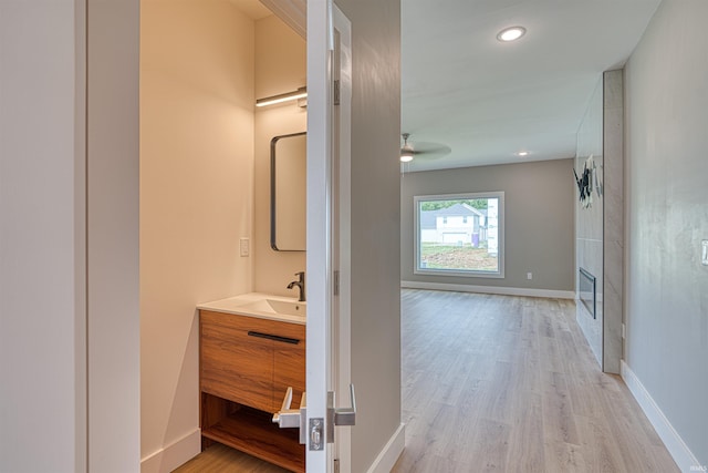 3605 Sand Dr, Newburgh, IN 47630 - hall featuring a sink, light wood-type flooring, baseboards, and recessed lighting