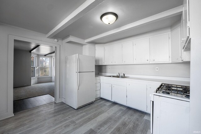 1437 Oakland St, Fort Wayne, IN 46808 - kitchen featuring white appliances, a sink, light wood finished floors, beamed ceiling, and light countertops