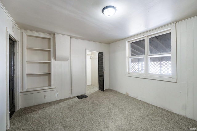 1437 Oakland St, Fort Wayne, IN 46808 - unfurnished bedroom with carpet floors and wooden walls