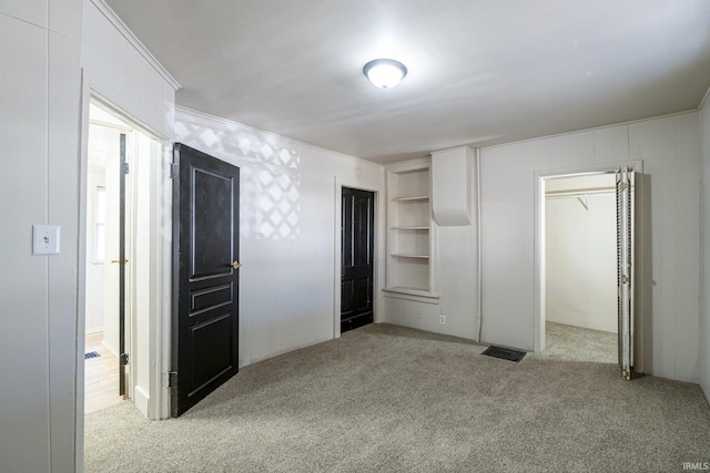 1437 Oakland St, Fort Wayne, IN 46808 - unfurnished bedroom with carpet, ornamental molding, and a spacious closet