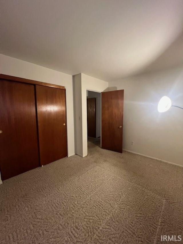 406 E Maple St, Attica, IN 47918 - unfurnished bedroom with carpet floors, a closet, and baseboards
