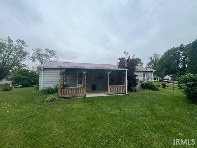 406 E Maple St, Attica, IN 47918 - rear view of property featuring a yard and metal roof