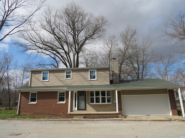 2607 S Airport Rd, Monticello, IN 47960 - traditional-style house featuring a chimney, an attached garage, brick siding, and driveway
