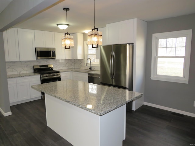 2607 S Airport Rd, Monticello, IN 47960 - kitchen with stainless steel appliances, a chandelier, backsplash, and dark wood-style flooring
