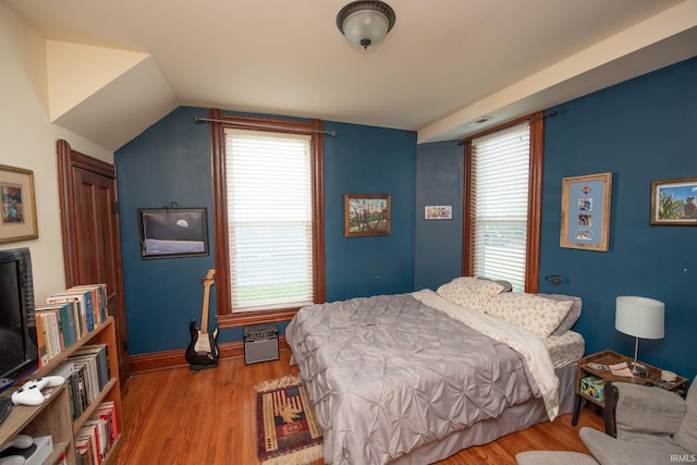 1422 Virginia St, Lafayette, IN 47905 - bedroom with wood finished floors, multiple windows, vaulted ceiling, and baseboards