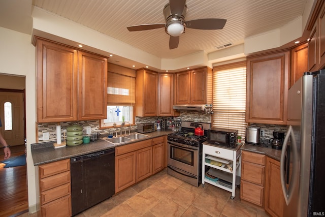 1422 Virginia St, Lafayette, IN 47905 - kitchen featuring stainless steel appliances, a sink, under cabinet range hood, and dark countertops