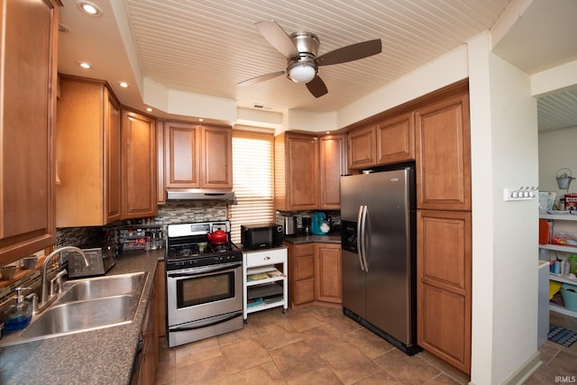 1422 Virginia St, Lafayette, IN 47905 - kitchen with stainless steel appliances, a sink, under cabinet range hood, brown cabinetry, and dark countertops