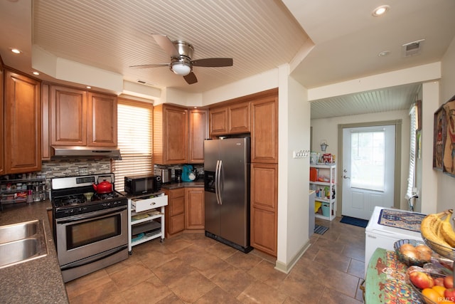 1422 Virginia St, Lafayette, IN 47905 - kitchen with stainless steel appliances, brown cabinetry, dark countertops, decorative backsplash, and ceiling fan