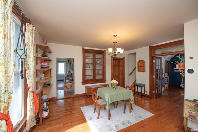 1422 Virginia St, Lafayette, IN 47905 - dining space featuring a chandelier, light wood-style floors, and baseboards
