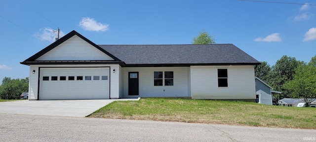 377 N 3rd St, Montgomery, IN 47558 - view of front of property featuring a garage, driveway, and a front lawn