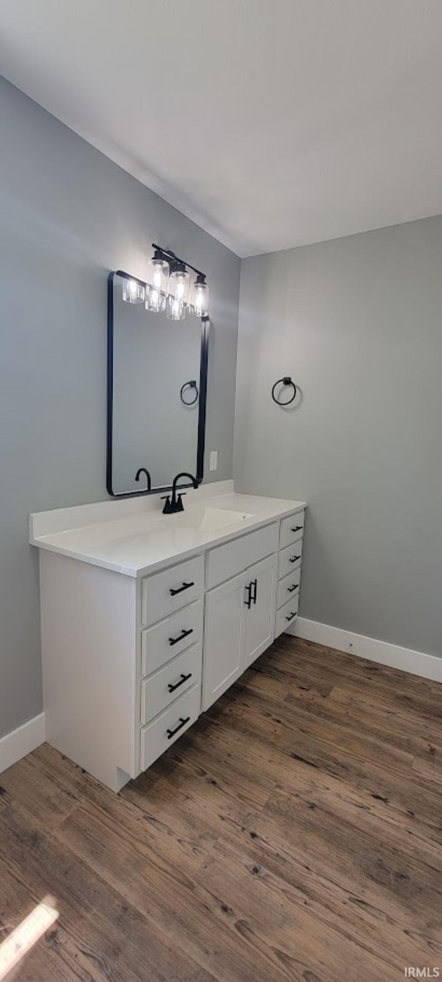377 N 3rd St, Montgomery, IN 47558 - bathroom with wood finished floors, vanity, and baseboards