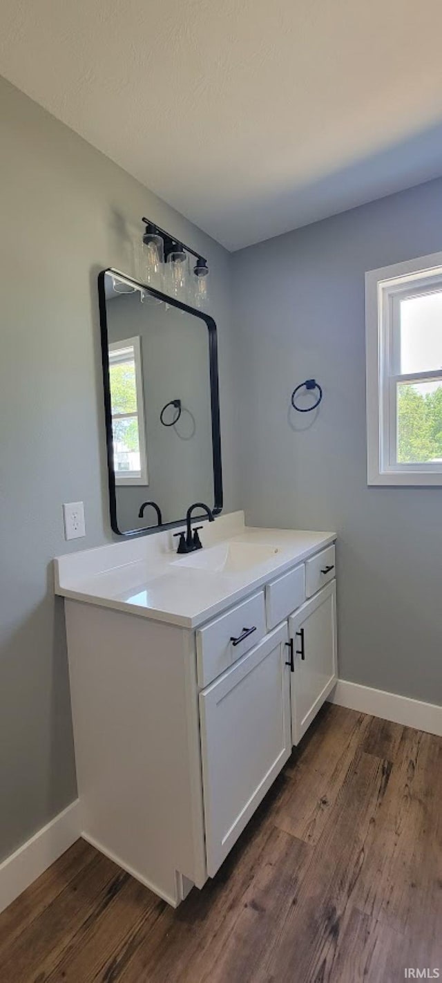 377 N 3rd St, Montgomery, IN 47558 - bathroom featuring wood finished floors, vanity, plenty of natural light, and baseboards