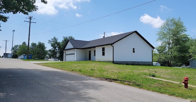 377 N 3rd St, Montgomery, IN 47558 - view of property exterior featuring an attached garage, a yard, and driveway
