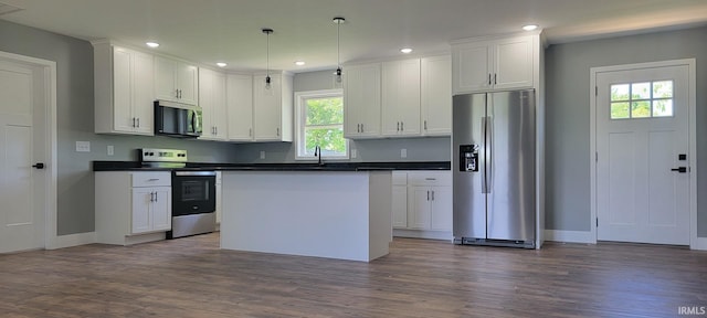 377 N 3rd St, Montgomery, IN 47558 - kitchen with appliances with stainless steel finishes, plenty of natural light, dark countertops, dark wood finished floors, and recessed lighting