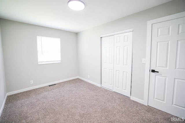 904 Hall Ave, Oolitic, IN 47446 - unfurnished bedroom featuring carpet floors, a closet, and baseboards