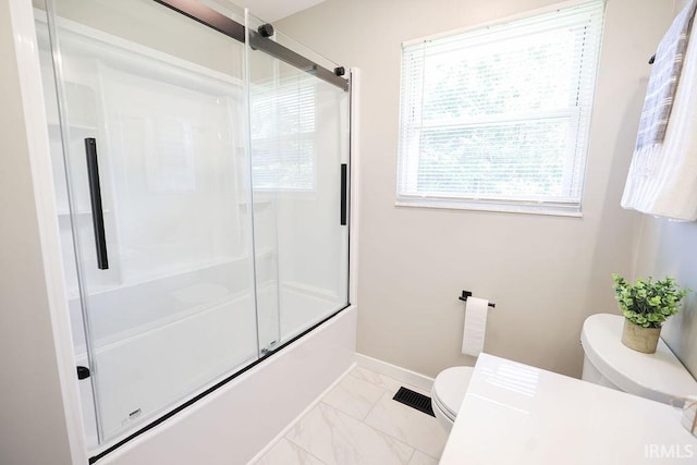 904 Hall Ave, Oolitic, IN 47446 - bathroom featuring toilet, marble look tiles, baseboards, and enclosed tub / shower combo