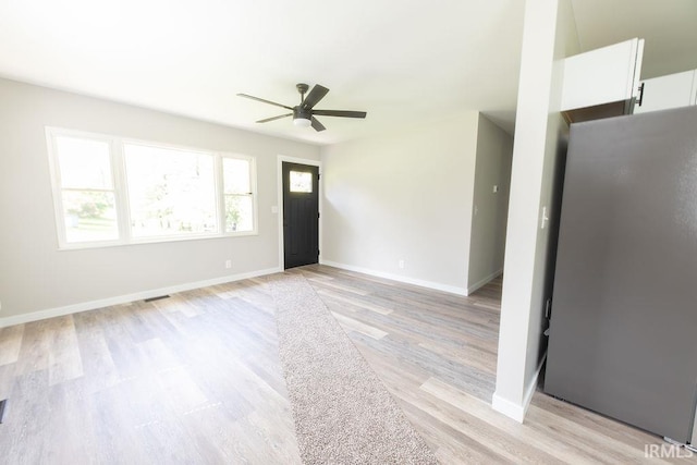 904 Hall Ave, Oolitic, IN 47446 - unfurnished living room with a ceiling fan, light wood finished floors, and baseboards