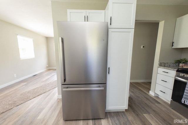 904 Hall Ave, Oolitic, IN 47446 - kitchen featuring stainless steel appliances, white cabinetry, and light wood-style floors