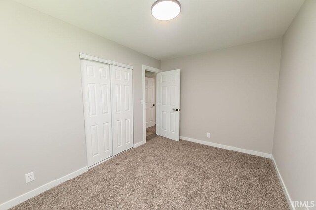 904 Hall Ave, Oolitic, IN 47446 - unfurnished bedroom with carpet, baseboards, and a closet