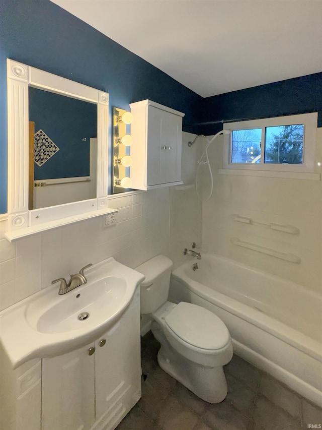 2301 E Delaware St, Evansville, IN 47711 - bathroom with toilet, tile walls, shower / bath combination, vanity, and tile patterned flooring