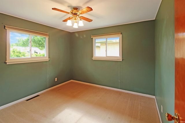 2301 E Delaware St, Evansville, IN 47711 - unfurnished room featuring healthy amount of natural light, a ceiling fan, and carpet flooring