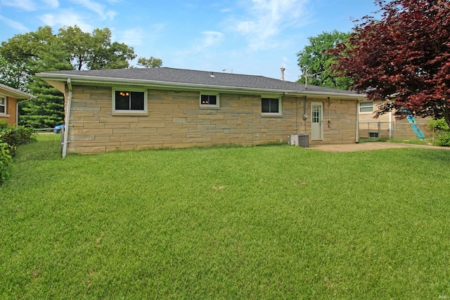 2301 E Delaware St, Evansville, IN 47711 - rear view of property featuring a patio area, stone siding, central AC, and a shingled roof
