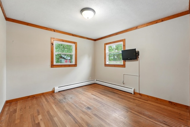 303 Fieldcrest Dr, Angola, IN 46703 - unfurnished room with hardwood / wood-style floors, a baseboard heating unit, and baseboards