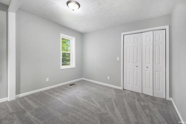 10974 County Road 10, Middlebury, IN 46540 - unfurnished bedroom with carpet, a textured ceiling, a closet, and baseboards