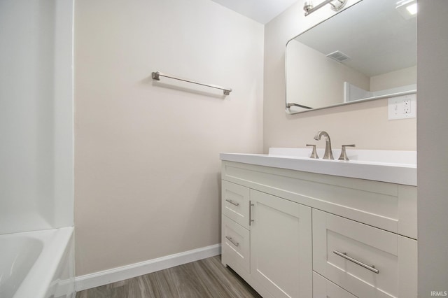 10974 County Road 10, Middlebury, IN 46540 - full bath featuring wood finished floors, baseboards, vanity, and a bath